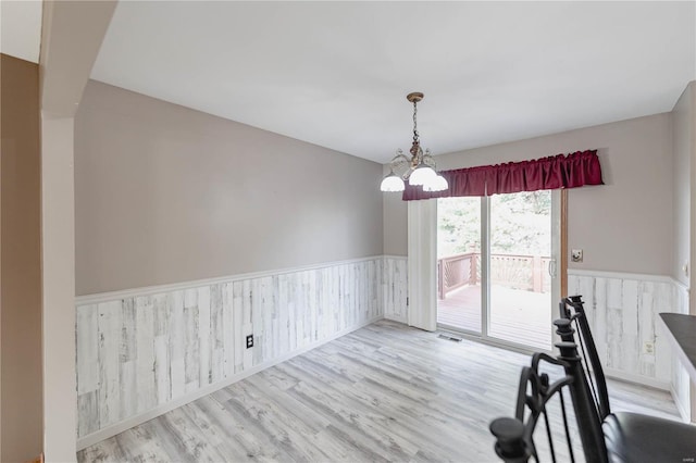 unfurnished dining area with light hardwood / wood-style floors