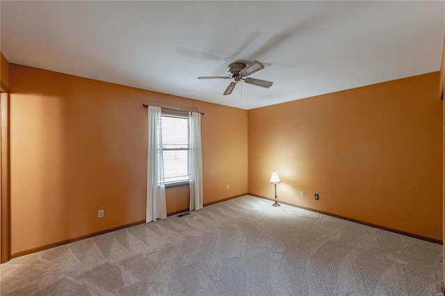 spare room featuring ceiling fan and light carpet