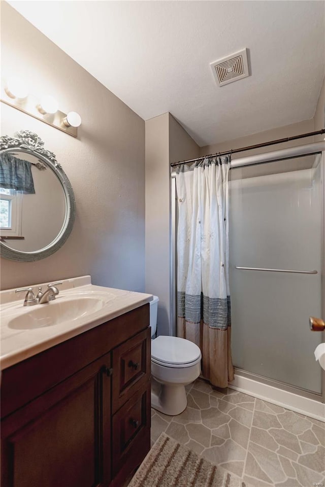 bathroom with vanity, toilet, and a shower with curtain