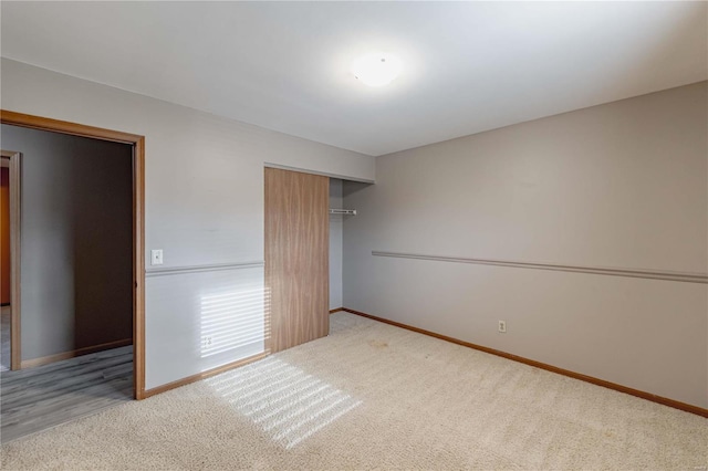 unfurnished bedroom with a closet and carpet flooring