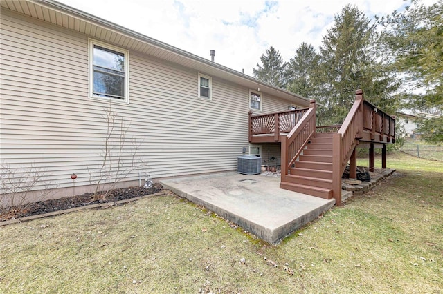 view of property exterior with a wooden deck, central AC, a lawn, and a patio