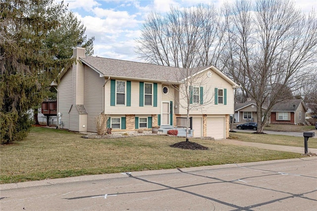 raised ranch featuring a garage and a front yard