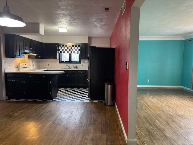 kitchen featuring pendant lighting, sink, white electric range, dark wood-type flooring, and black fridge