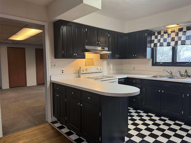 kitchen featuring sink, white electric range oven, and kitchen peninsula