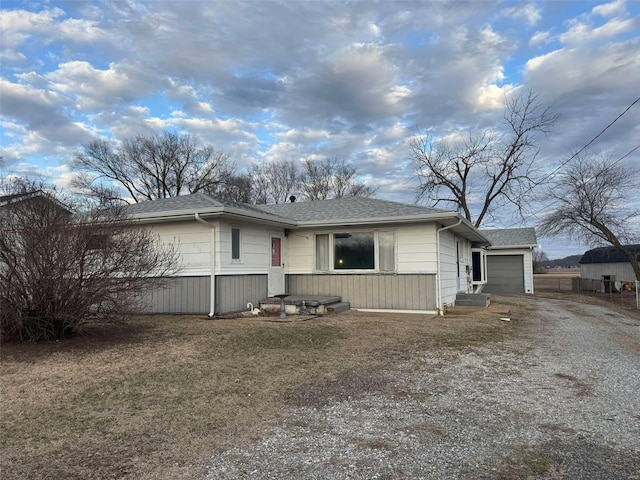 ranch-style house with a garage and a front yard