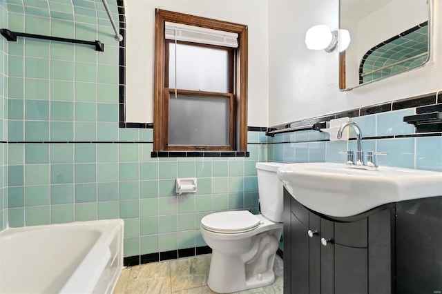 bathroom with vanity, a bath, toilet, and tile walls