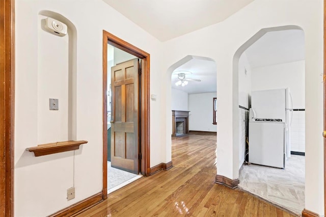 corridor with light wood-type flooring