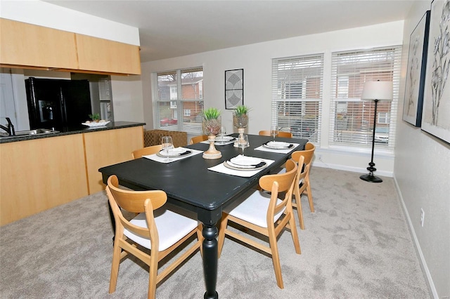 carpeted dining room with sink