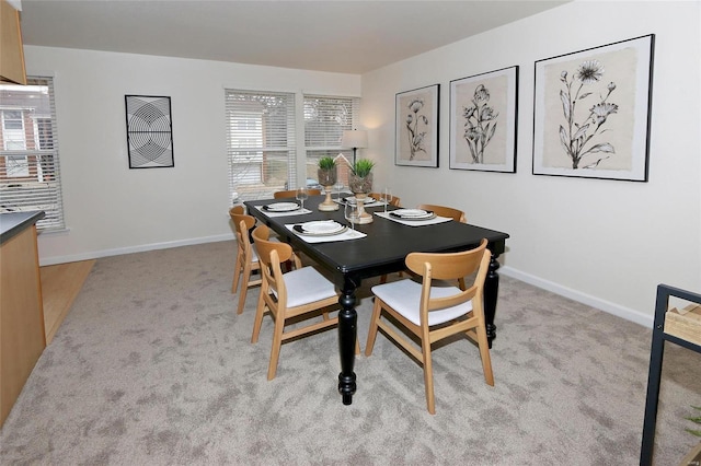 dining room with light colored carpet