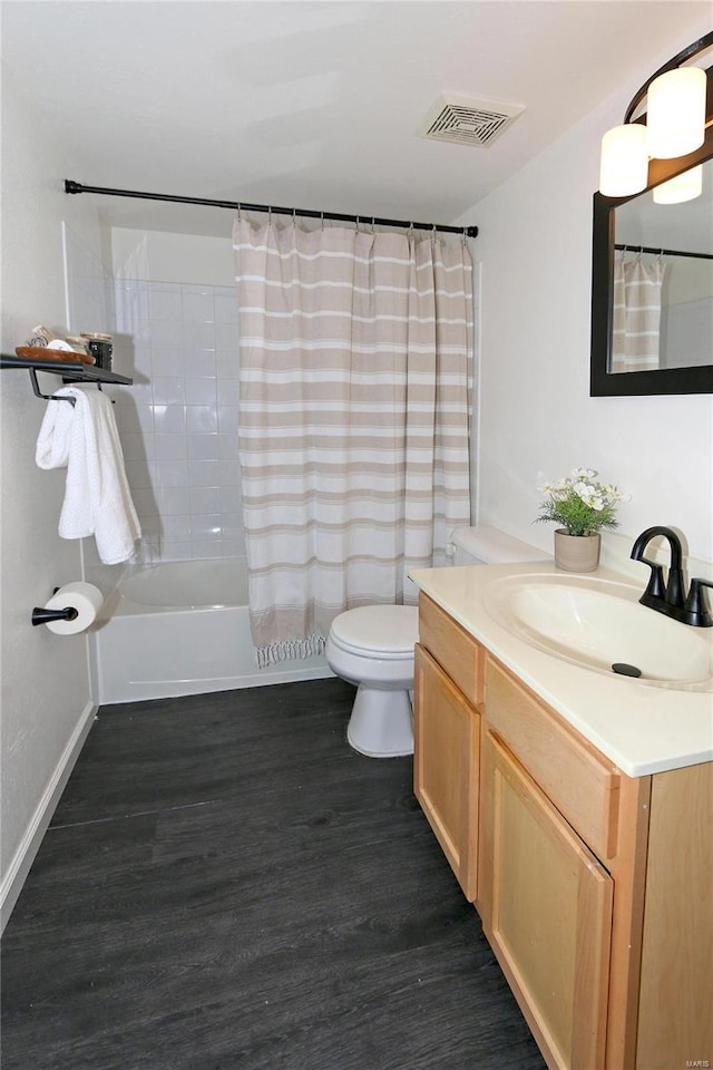 full bathroom with shower / bathtub combination with curtain, vanity, hardwood / wood-style flooring, and toilet