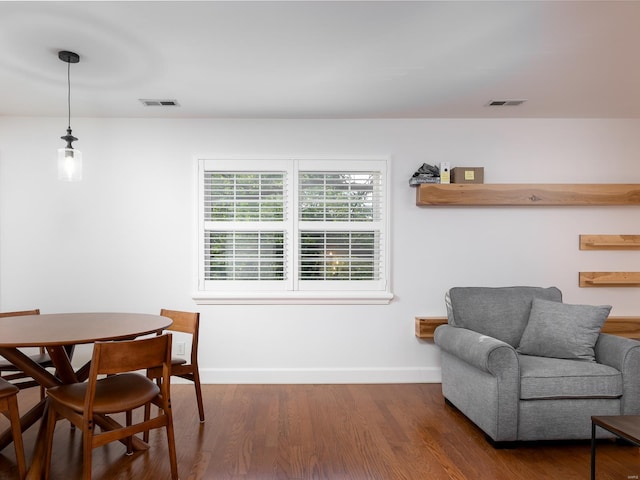 dining space with dark hardwood / wood-style flooring