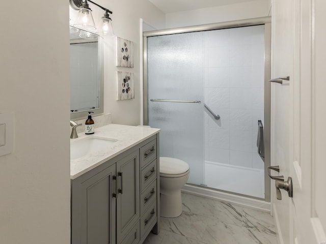 bathroom featuring vanity, an enclosed shower, and toilet