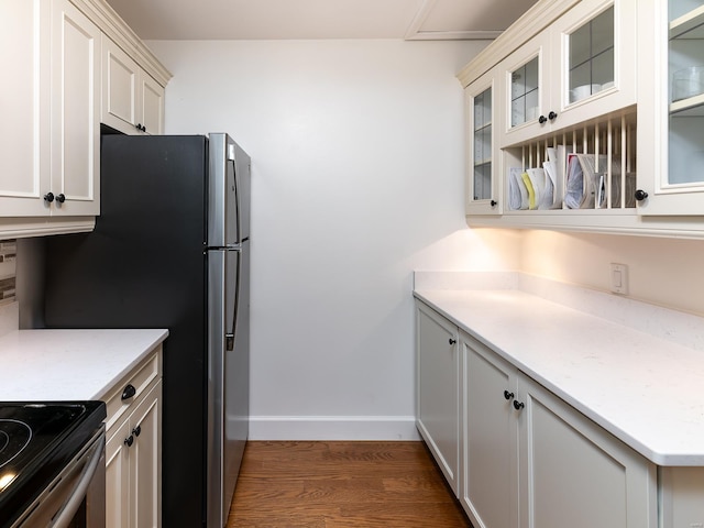 kitchen featuring light stone counters, white cabinets, and dark hardwood / wood-style flooring