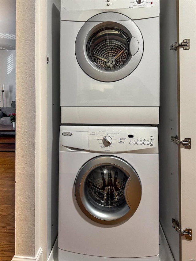 washroom with stacked washer / drying machine