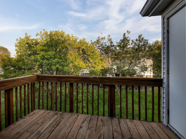 wooden deck with a lawn