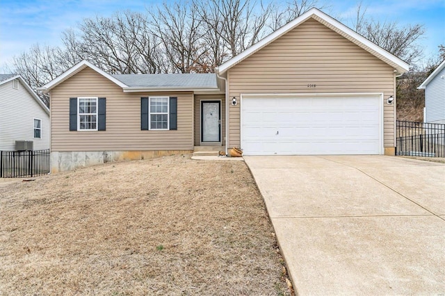 view of front of home with central AC unit and a garage