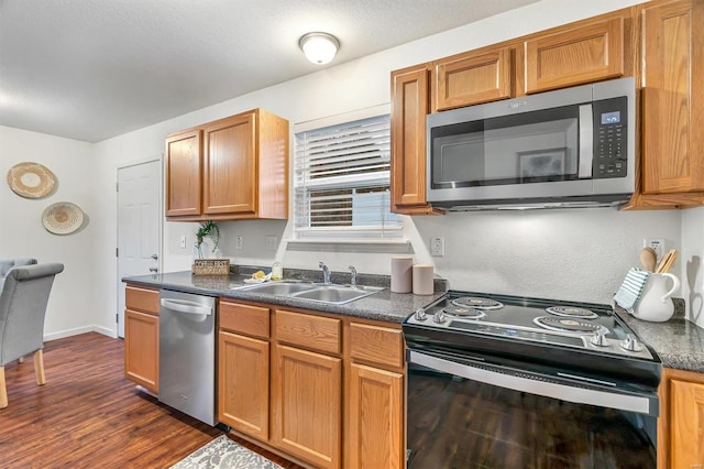 kitchen featuring dark hardwood / wood-style flooring, sink, and appliances with stainless steel finishes