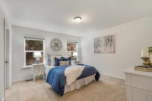 bedroom featuring light carpet