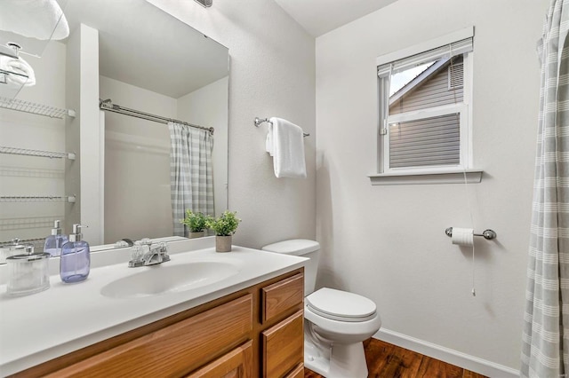 bathroom with hardwood / wood-style flooring, vanity, and toilet