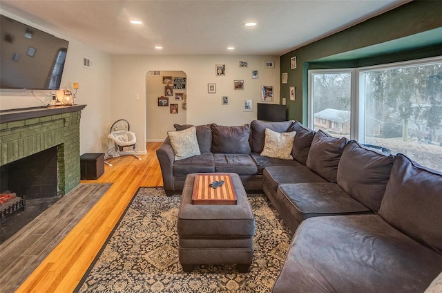 living room with hardwood / wood-style flooring and a fireplace