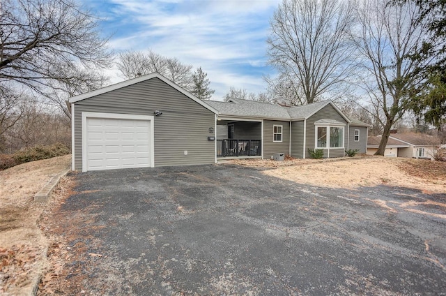 ranch-style home featuring a porch and a garage