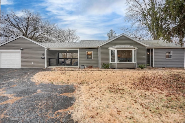 ranch-style house featuring a porch and a garage