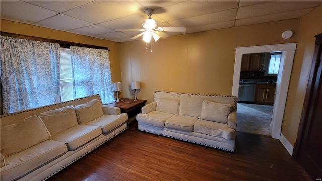 living room with dark hardwood / wood-style floors, a paneled ceiling, and ceiling fan