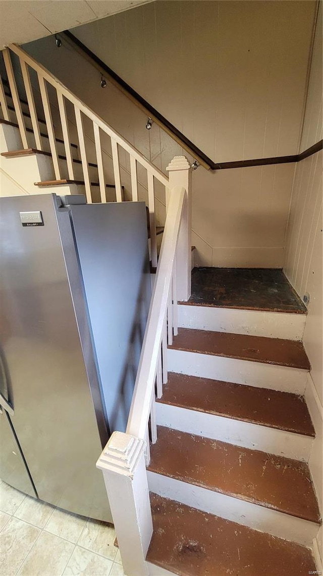 staircase featuring tile patterned flooring