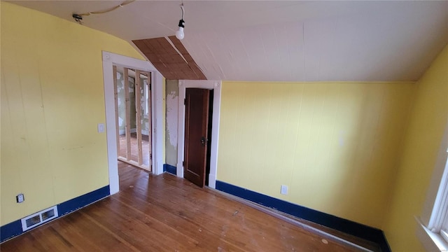 interior space featuring dark hardwood / wood-style flooring and vaulted ceiling