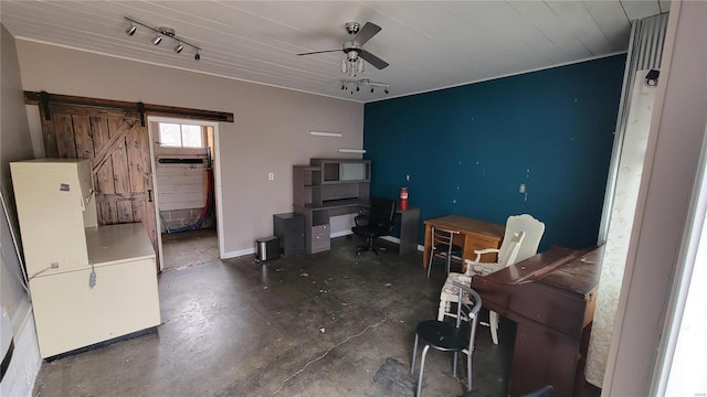 office space with ceiling fan, a barn door, and rail lighting