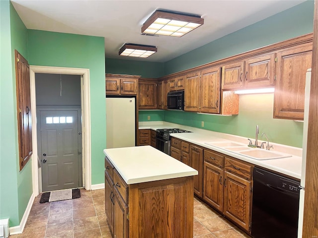 kitchen with brown cabinetry, a kitchen island, a sink, black appliances, and baseboards