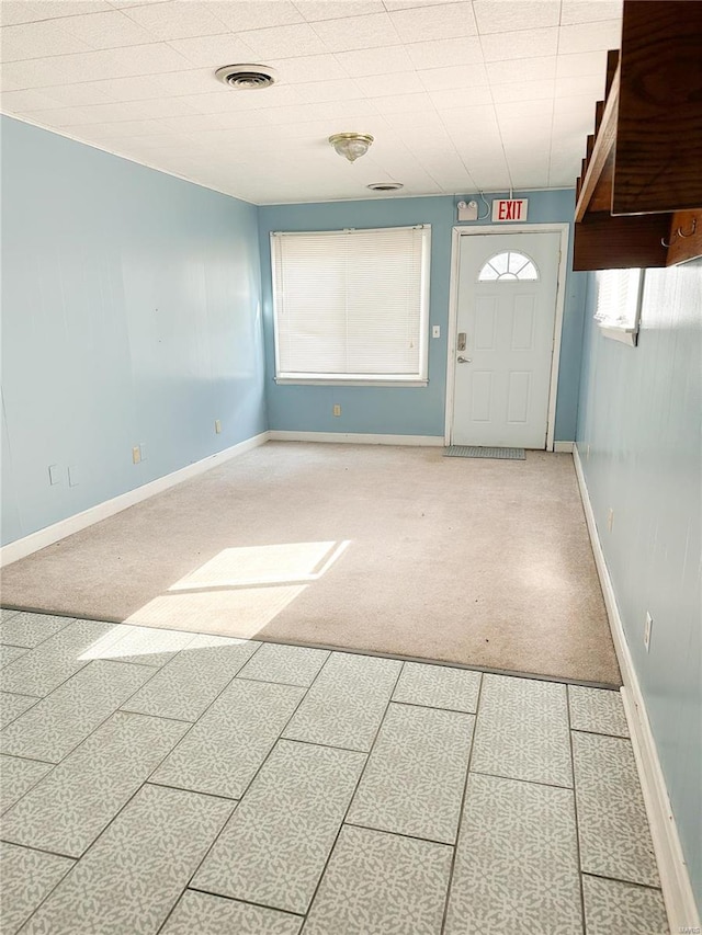 entryway with baseboards and visible vents