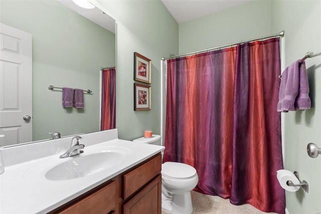 bathroom with curtained shower, vanity, and toilet