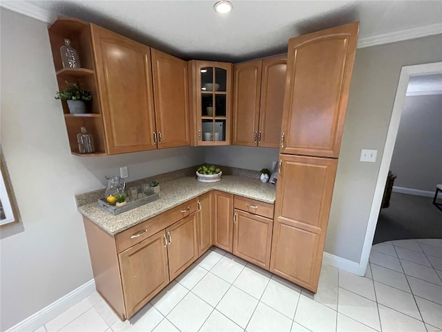 kitchen with light tile patterned flooring and light stone countertops