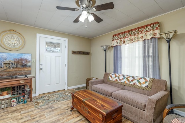 living room featuring ornamental molding, hardwood / wood-style floors, and ceiling fan