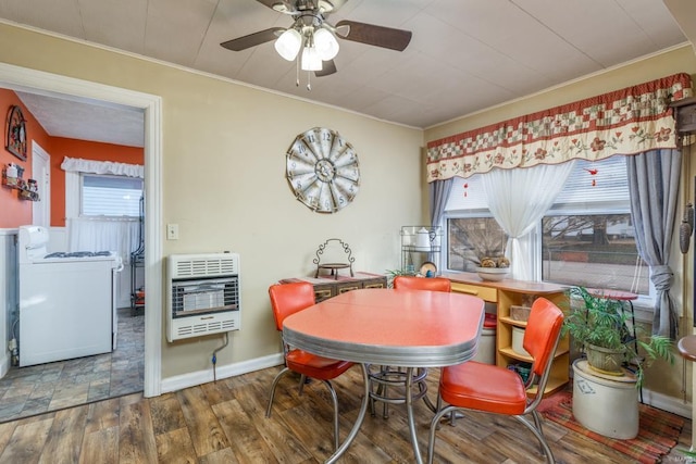 dining area featuring washer / clothes dryer, crown molding, dark hardwood / wood-style floors, and heating unit