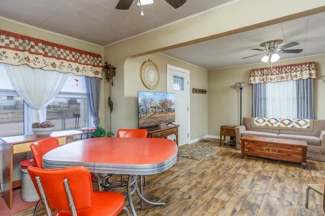 dining room featuring ornamental molding, plenty of natural light, hardwood / wood-style floors, and ceiling fan