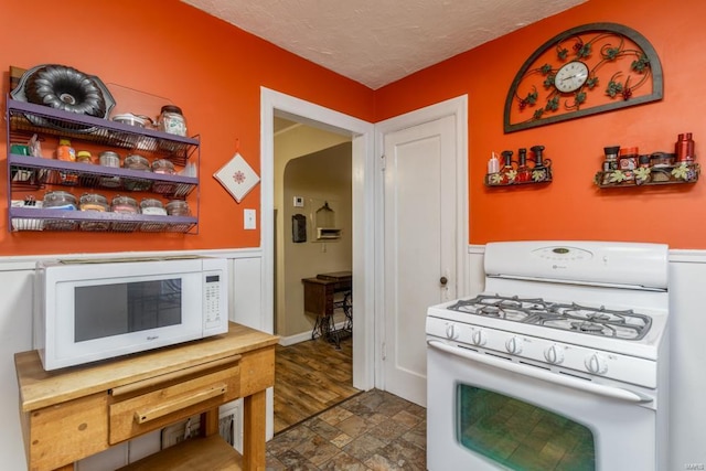 kitchen with white appliances and a textured ceiling