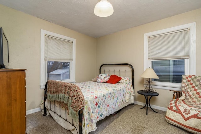 carpeted bedroom with a textured ceiling