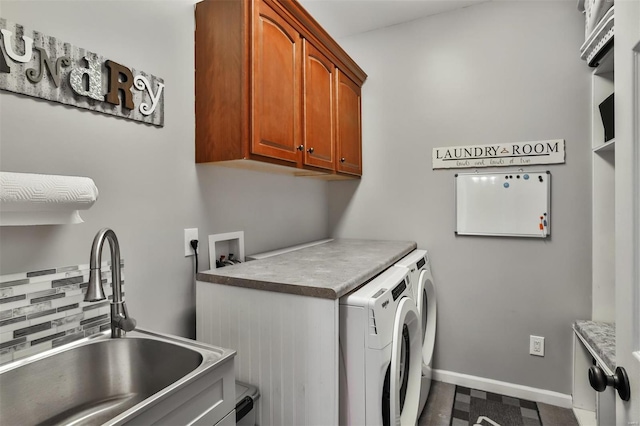 laundry area with cabinets, sink, and washing machine and clothes dryer