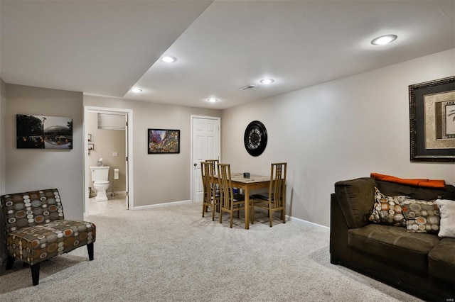 dining space featuring light carpet