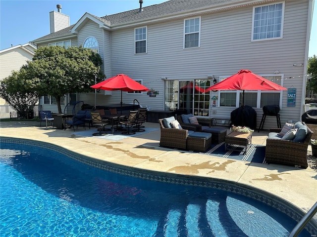 rear view of property with a patio area and outdoor lounge area