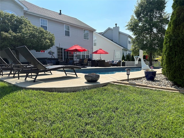 view of pool with a patio and a yard