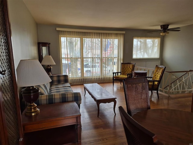 living room featuring dark hardwood / wood-style flooring and ceiling fan