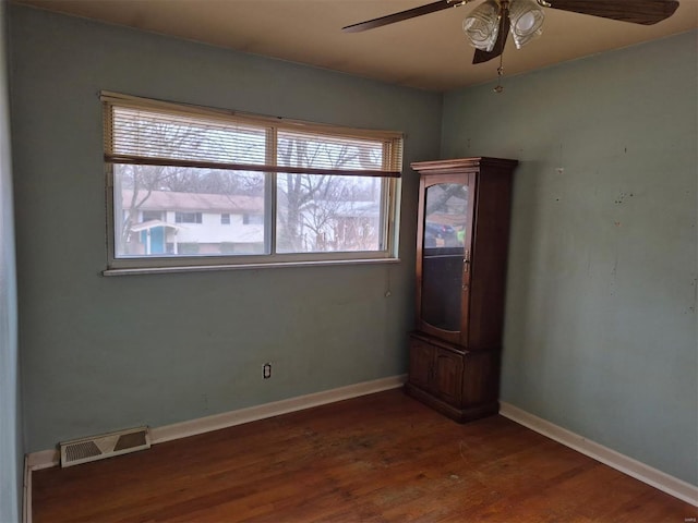 empty room featuring hardwood / wood-style flooring and ceiling fan