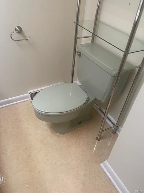 bathroom with baseboards and toilet