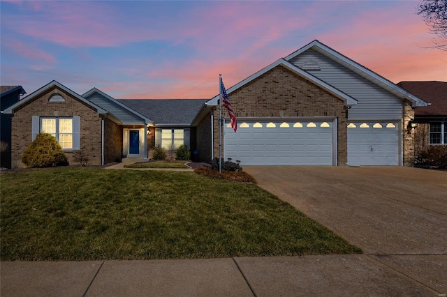 ranch-style home featuring brick siding, a yard, driveway, and a garage