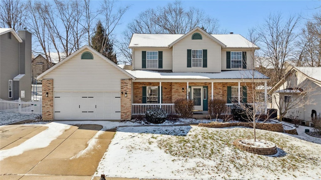 view of property featuring a garage and a porch