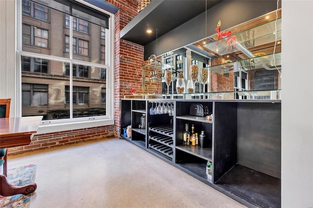 bar featuring brick wall and concrete flooring