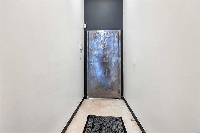 doorway featuring baseboards